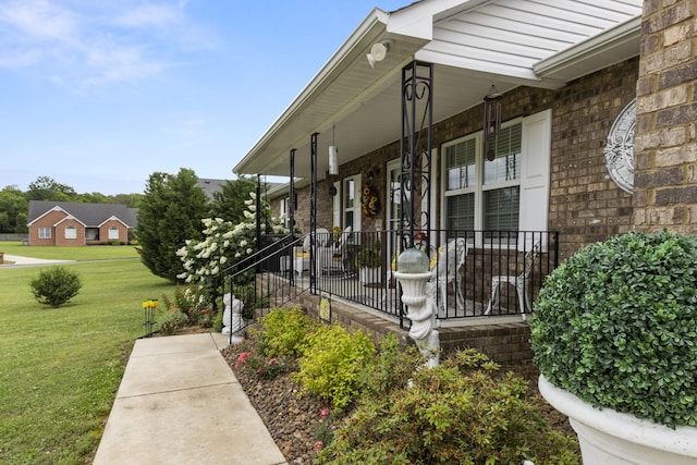 147 Crimson Dr, Winchester, TN 37398 - view of exterior entry with a porch, a lawn, and brick siding