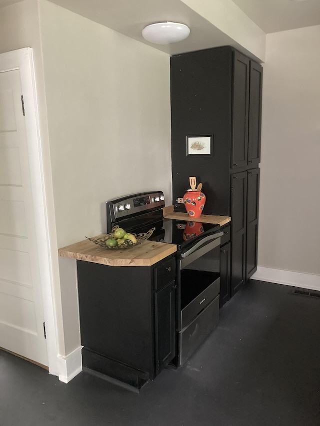 1402 Clarke St, Old Hickory, TN 37138 - bar featuring stainless steel electric stove, finished concrete flooring, and baseboards