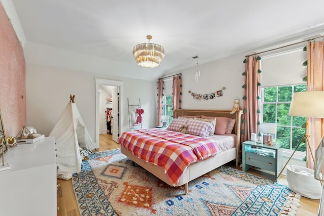 1040B Battery Ln E, Nashville, TN 37220 - bedroom with light wood finished floors, a chandelier, a spacious closet, and a closet