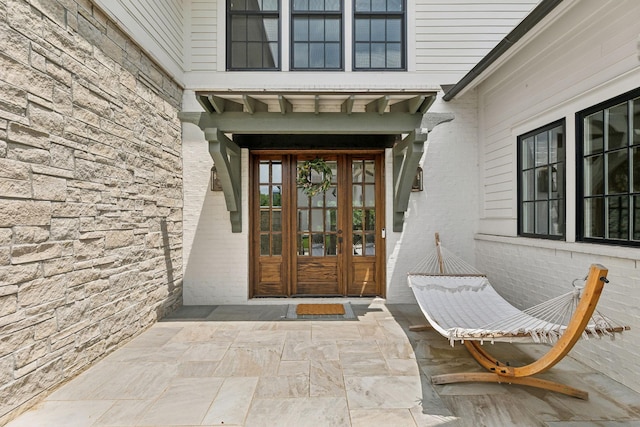 1040B Battery Ln E, Nashville, TN 37220 - doorway to property featuring stone siding, french doors, and brick siding