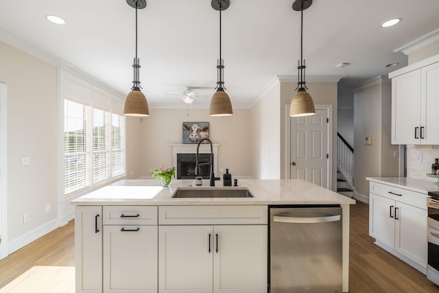 100 Nancy Ct, Hermitage, TN 37076 - kitchen with stainless steel dishwasher, a sink, ornamental molding, a fireplace, and light wood-type flooring
