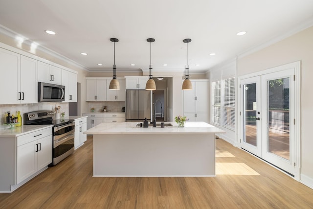 100 Nancy Ct, Hermitage, TN 37076 - kitchen with appliances with stainless steel finishes, a sink, an island with sink, white cabinetry, and light wood-type flooring