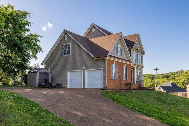 100 Nancy Ct, Hermitage, TN 37076 - view of side of home with driveway, an attached garage, a shingled roof, and brick siding