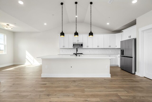 0 Stonehorn Dr, Bell Buckle, TN 37020 - kitchen featuring stainless steel appliances, vaulted ceiling, light countertops, white cabinets, and backsplash