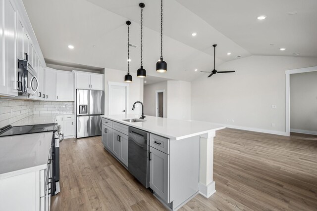 0 Stonehorn Dr, Bell Buckle, TN 37020 - kitchen with appliances with stainless steel finishes, a sink, lofted ceiling, backsplash, and light wood-type flooring