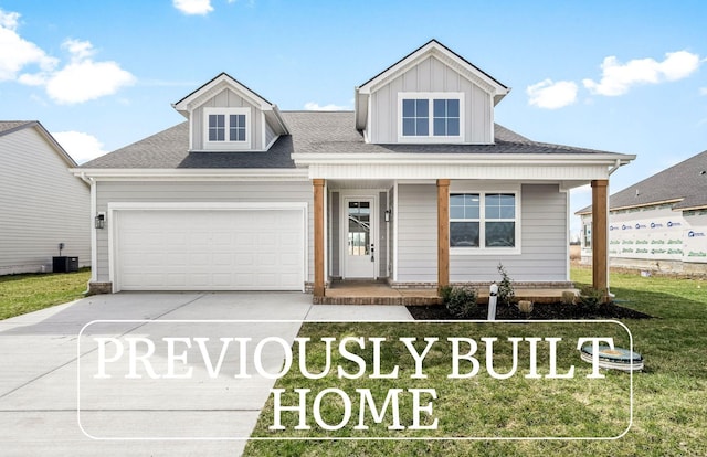 0 Stonehorn Dr, Bell Buckle, TN 37020 - view of front of property featuring a porch, concrete driveway, an attached garage, central air condition unit, and a front yard