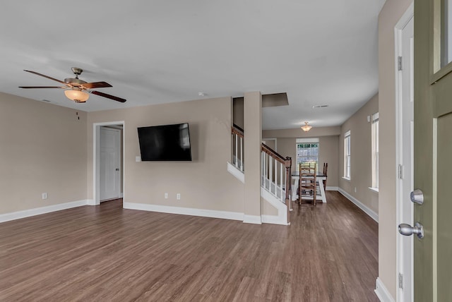 421 Willis Way, Columbia, TN 38401 - unfurnished living room featuring wood finished floors, baseboards, a ceiling fan, and stairway