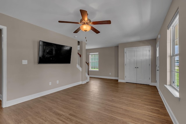 421 Willis Way, Columbia, TN 38401 - unfurnished living room featuring light wood finished floors, plenty of natural light, stairway, and a ceiling fan