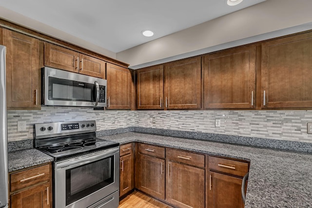 421 Willis Way, Columbia, TN 38401 - kitchen with stainless steel appliances, dark stone countertops, tasteful backsplash, and light wood finished floors