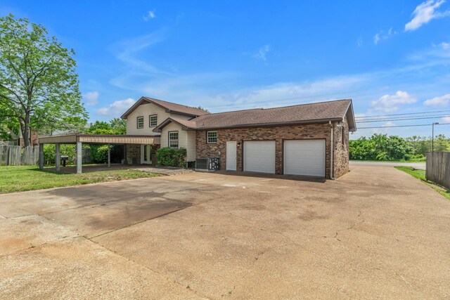 520 Almaville Rd, Smyrna, TN 37167 - view of front facade with central AC, an attached garage, brick siding, roof with shingles, and concrete driveway