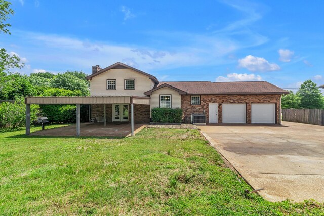 520 Almaville Rd, Smyrna, TN 37167 - view of front of home with french doors, an attached garage, cooling unit, a chimney, and concrete driveway