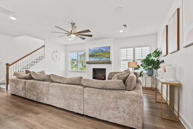 400 Parker Ct, Antioch, TN 37013 - living room featuring ceiling fan, a glass covered fireplace, recessed lighting, wood finished floors, and stairs