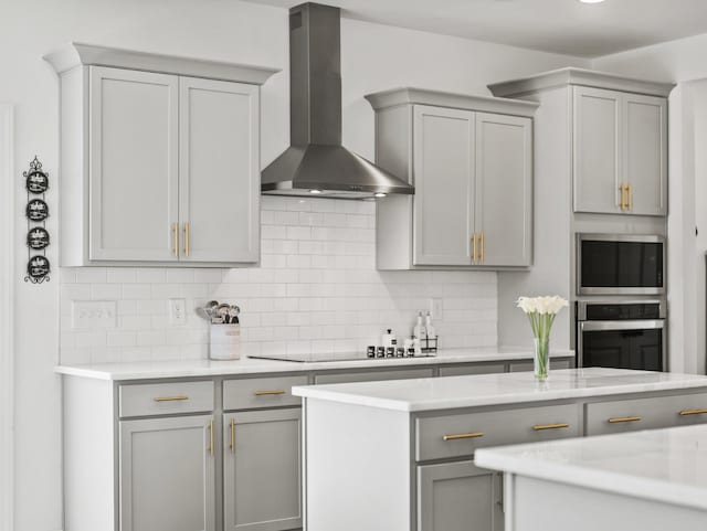 400 Parker Ct, Antioch, TN 37013 - kitchen featuring wall chimney exhaust hood, gray cabinets, stainless steel appliances, decorative backsplash, and light countertops