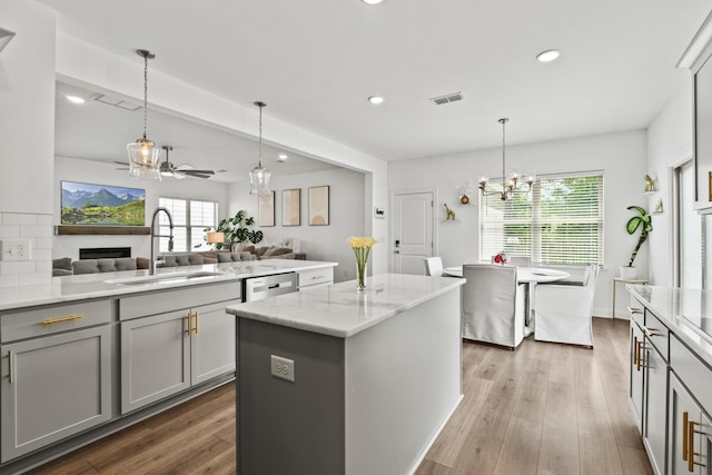 400 Parker Ct, Antioch, TN 37013 - kitchen featuring a sink, gray cabinetry, open floor plan, recessed lighting, and a fireplace