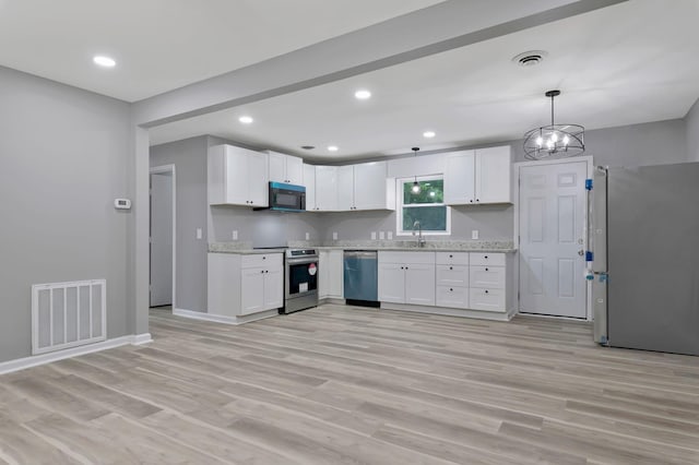 4904 Algonquin Trl, Antioch, TN 37013 - kitchen featuring stainless steel appliances, a sink, light wood finished floors, white cabinetry, and recessed lighting