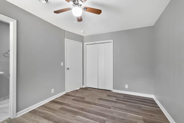4904 Algonquin Trl, Antioch, TN 37013 - unfurnished bedroom with baseboards, a closet, wood finished floors, and a ceiling fan