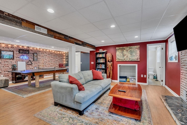 415 Isaac Dr, Goodlettsville, TN 37072 - living area with wood finished floors, brick wall, a paneled ceiling, baseboards, and recessed lighting