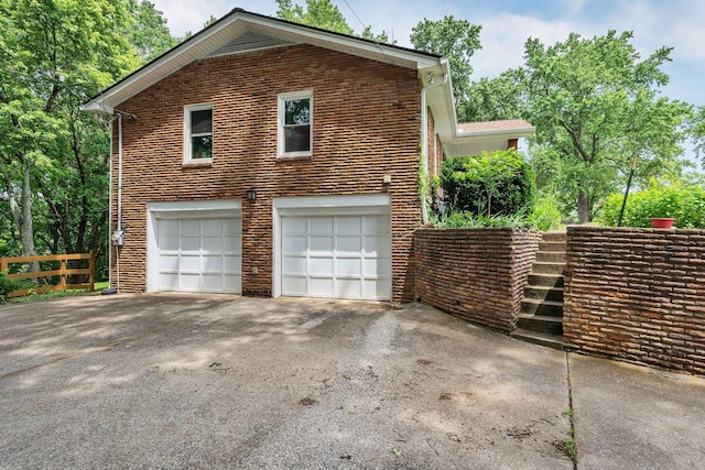 415 Isaac Dr, Goodlettsville, TN 37072 - view of property exterior with asphalt driveway, a garage, and brick siding