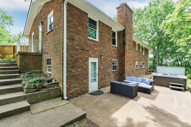 415 Isaac Dr, Goodlettsville, TN 37072 - back of house with a patio, outdoor lounge area, a hot tub, stairway, and a chimney