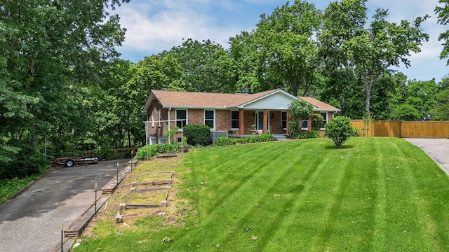 415 Isaac Dr, Goodlettsville, TN 37072 - single story home with brick siding, covered porch, central AC unit, and driveway
