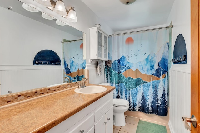 415 Isaac Dr, Goodlettsville, TN 37072 - bathroom with tile patterned flooring, wainscoting, vanity, toilet, and shower / tub combo with curtain