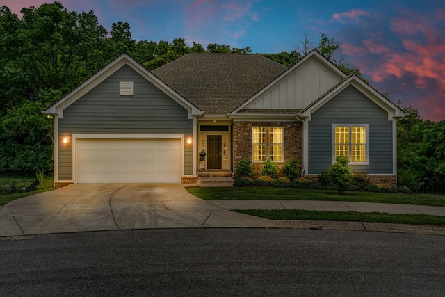 817 Tanager Pl, Lebanon, TN 37087 - view of front of home with board and batten siding, concrete driveway, an attached garage, brick siding, and a shingled roof