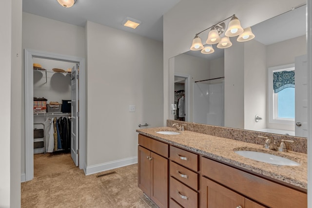 817 Tanager Pl, Lebanon, TN 37087 - full bathroom featuring baseboards, double vanity, and a walk in closet