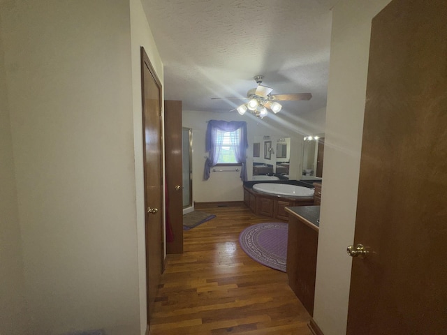 325 Lafayette Ct, Moss, TN 38575 - bathroom featuring wood finished floors, vanity, ceiling fan, a stall shower, and vaulted ceiling