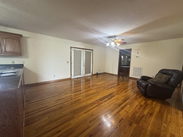 325 Lafayette Ct, Moss, TN 38575 - living room with hardwood / wood-style flooring, a textured ceiling, ceiling fan, and baseboards