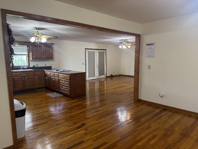 325 Lafayette Ct, Moss, TN 38575 - kitchen featuring ceiling fan, a sink, dark wood-type flooring, dark countertops, and a textured ceiling