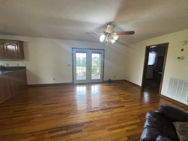 325 Lafayette Ct, Moss, TN 38575 - unfurnished living room featuring wood finished floors, a ceiling fan, baseboards, french doors, and a textured ceiling