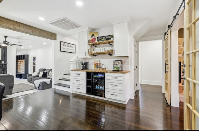 117 Park Cir, Columbia, TN 38401 - indoor dry bar with wine cooler, a barn door, dark wood-type flooring, decorative backsplash, and a ceiling fan