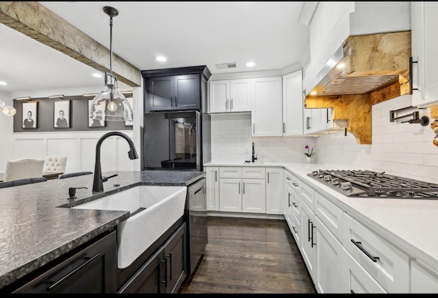 117 Park Cir, Columbia, TN 38401 - kitchen with black refrigerator, gas cooktop, stainless steel dishwasher, wall chimney range hood, and a sink