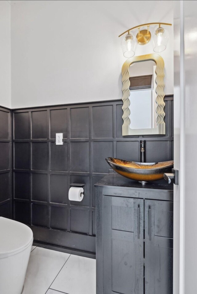 117 Park Cir, Columbia, TN 38401 - bathroom featuring a decorative wall, toilet, vanity, tile patterned floors, and wainscoting