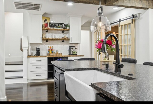 117 Park Cir, Columbia, TN 38401 - kitchen with a sink, dark countertops, white cabinetry, dark wood finished floors, and decorative light fixtures