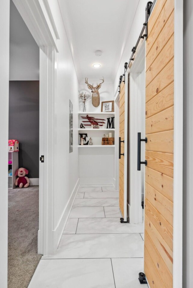 117 Park Cir, Columbia, TN 38401 - hallway with a barn door, marble look tile flooring, and baseboards