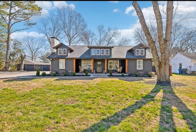 117 Park Cir, Columbia, TN 38401 - view of front facade with a porch, a front yard, a chimney, and roof with shingles
