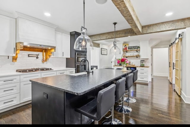 117 Park Cir, Columbia, TN 38401 - kitchen with stainless steel appliances, backsplash, dark wood finished floors, a sink, and white cabinets