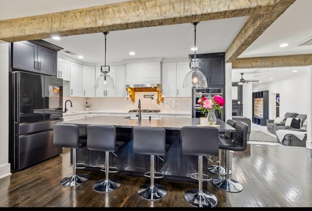 117 Park Cir, Columbia, TN 38401 - kitchen with freestanding refrigerator, custom range hood, stainless steel double oven, dark wood-style flooring, and backsplash