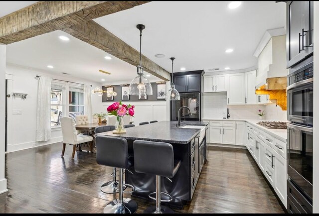 117 Park Cir, Columbia, TN 38401 - kitchen with stainless steel gas cooktop, recessed lighting, tasteful backsplash, a sink, and a kitchen bar