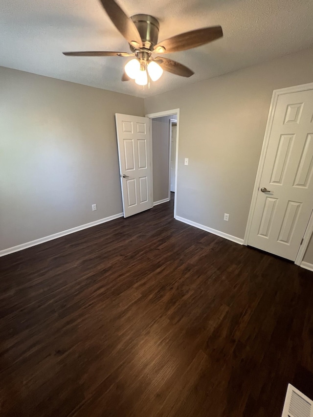 1846 Patrick Rd, Pulaski, TN 38478 - unfurnished bedroom with baseboards, dark wood-type flooring, and ceiling fan