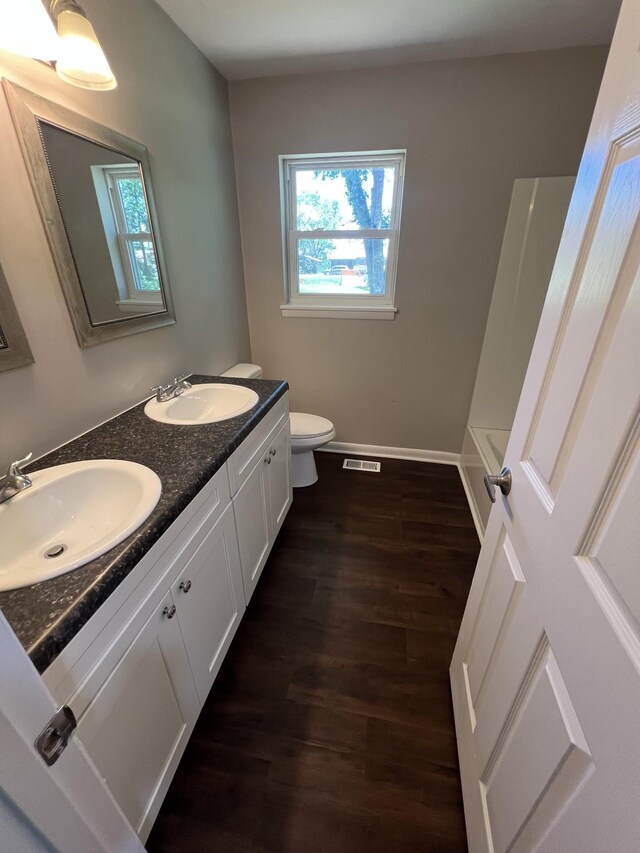 1846 Patrick Rd, Pulaski, TN 38478 - bathroom with wood finished floors, toilet, double vanity, and baseboards