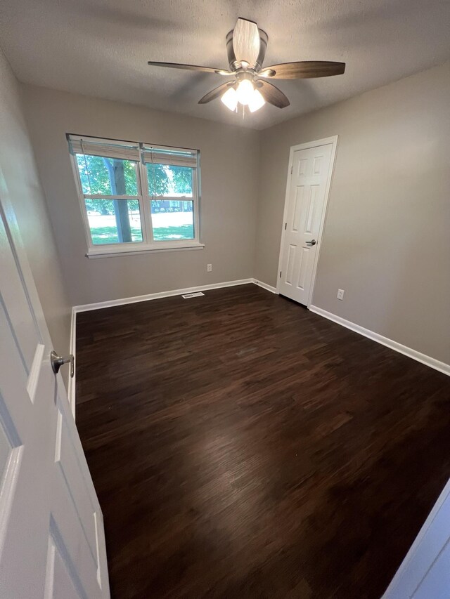 1846 Patrick Rd, Pulaski, TN 38478 - empty room with dark wood-type flooring, ceiling fan, baseboards, and a textured ceiling