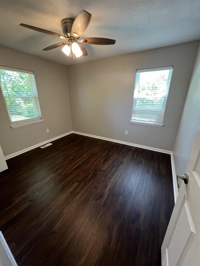 1846 Patrick Rd, Pulaski, TN 38478 - unfurnished room featuring dark wood-type flooring, ceiling fan, baseboards, and a textured ceiling