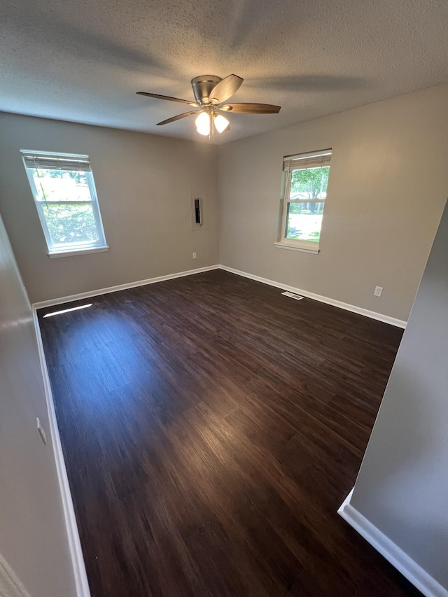 1846 Patrick Rd, Pulaski, TN 38478 - empty room with dark wood-style flooring, ceiling fan, a textured ceiling, and baseboards