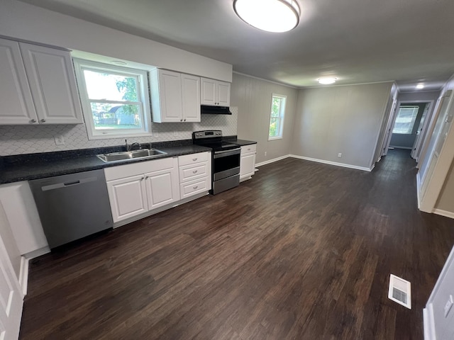 1846 Patrick Rd, Pulaski, TN 38478 - kitchen with appliances with stainless steel finishes, a sink, under cabinet range hood, dark countertops, and backsplash