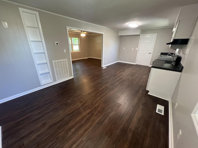 1846 Patrick Rd, Pulaski, TN 38478 - kitchen featuring crown molding, built in features, dark countertops, dark wood-style flooring, and baseboards