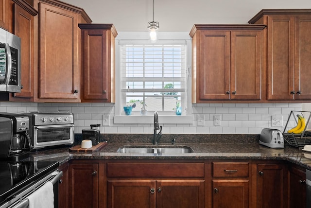258 Bellshire Dr, Clarksville, TN 37043 - kitchen featuring a sink, stainless steel microwave, decorative backsplash, and dark stone counters