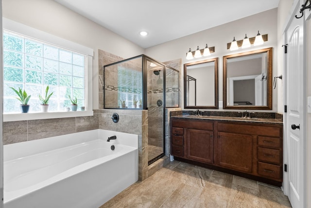 258 Bellshire Dr, Clarksville, TN 37043 - bathroom featuring a bath, a shower stall, double vanity, and recessed lighting