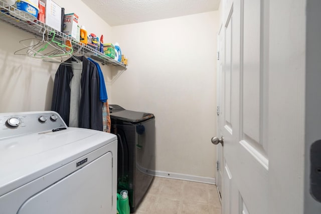 214 Cobblestone Lndg, Mount Juliet, TN 37122 - washroom with washing machine and dryer, baseboards, and a textured ceiling